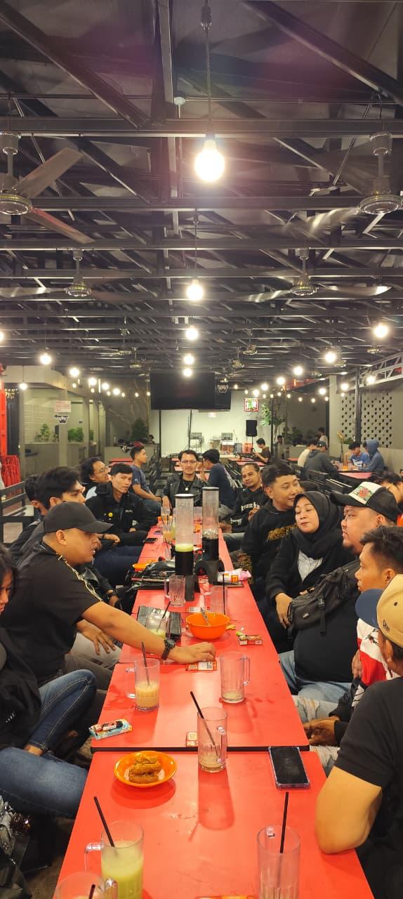 Anggota klub berbincang di meja panjang